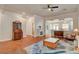 Open-concept living room with hardwood floors, elegant furnishings, and natural light at 708 Canterbury Cross Pl, Las Vegas, NV 89144