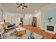 Bright living room featuring hardwood floors, ceiling fan and a charming fireplace at 708 Canterbury Cross Pl, Las Vegas, NV 89144