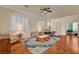 Elegant living room showcasing hardwood floors, plantation shutters, and a seamless flow into other living spaces at 708 Canterbury Cross Pl, Las Vegas, NV 89144