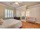 Spacious primary bedroom features hardwood floors, neutral walls, plantation shutters and bathroom access at 708 Canterbury Cross Pl, Las Vegas, NV 89144