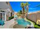 Outdoor pool with built-in waterfall feature and lounge chairs to relax by the water at 708 Canterbury Cross Pl, Las Vegas, NV 89144