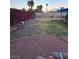 Spacious backyard featuring a mix of gravel, grass, and a privacy fence at 7200 Alta Dr, Las Vegas, NV 89145