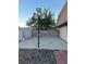 Backyard featuring a concrete slab, basketball hoop and two storage sheds at 7200 Alta Dr, Las Vegas, NV 89145