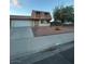 Charming two-story home featuring a well-maintained front yard with mature tree and gravel accents at 7200 Alta Dr, Las Vegas, NV 89145