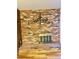 Close up of a decorative fireplace on a brick wall with a golden grate at 7200 Alta Dr, Las Vegas, NV 89145