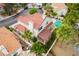 A beautiful home featuring a terracotta roof, a well-maintained yard, and lush trees surrounding the property at 7632 Spruce Run Ct, Las Vegas, NV 89128
