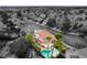 An aerial image of a property with a swimming pool, palm trees, and neighborhood view at 7632 Spruce Run Ct, Las Vegas, NV 89128