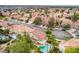 Expansive neighborhood aerial view featuring red-tiled roofs and lush landscaping at 7632 Spruce Run Ct, Las Vegas, NV 89128
