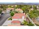 A beautiful home featuring a terracotta roof, a well-maintained yard, and lush trees surrounding the property at 7632 Spruce Run Ct, Las Vegas, NV 89128