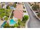 A lovely Gathering home featuring a backyard pool, green landscaping, and neighborhood view at 7632 Spruce Run Ct, Las Vegas, NV 89128