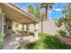 Covered back patio with ceiling fans, pillars, and view of backyard grass at 7632 Spruce Run Ct, Las Vegas, NV 89128