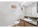 Powder room featuring a granite countertop, round window, and a modern vessel sink at 7632 Spruce Run Ct, Las Vegas, NV 89128