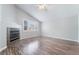 Spacious bedroom with a fireplace, shuttered windows, wood flooring and neutral paint at 7632 Spruce Run Ct, Las Vegas, NV 89128