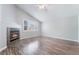 Spacious bedroom with a fireplace, shuttered windows, wood flooring and neutral paint at 7632 Spruce Run Ct, Las Vegas, NV 89128