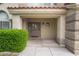 A close up of the home entrance with a gray colored door and landscaped entryway at 7632 Spruce Run Ct, Las Vegas, NV 89128