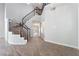 Bright entryway features a staircase with a black banister and views into other rooms of the home at 7632 Spruce Run Ct, Las Vegas, NV 89128