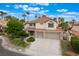 Charming two-story home with a well-manicured lawn, mature landscaping and a convenient two-car garage at 7632 Spruce Run Ct, Las Vegas, NV 89128