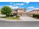 Two-story home with a red tile roof, three car garage and landscaped front yard on a sunny day at 7632 Spruce Run Ct, Las Vegas, NV 89128