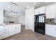 Eat-in kitchen with stone countertops, stainless steel refrigerator, and direct access to the living room at 7632 Spruce Run Ct, Las Vegas, NV 89128