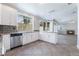 Bright kitchen featuring granite countertops, white cabinets, and stainless steel appliances with backyard views at 7632 Spruce Run Ct, Las Vegas, NV 89128