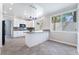 Bright kitchen features granite countertops, white cabinets, and stainless steel appliances at 7632 Spruce Run Ct, Las Vegas, NV 89128