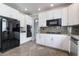 Gourmet kitchen featuring granite countertops, stainless appliances, modern cabinets, and tile floors at 7632 Spruce Run Ct, Las Vegas, NV 89128