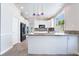 Bright kitchen features granite countertops, white cabinets, and stainless steel appliances at 7632 Spruce Run Ct, Las Vegas, NV 89128