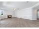 Open living room featuring fireplace, fan, neutral paint, and tile flooring at 7632 Spruce Run Ct, Las Vegas, NV 89128