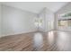 Spacious living room with soaring ceilings, laminate floors, with large windows and french doors at 7632 Spruce Run Ct, Las Vegas, NV 89128