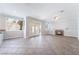 Spacious living room featuring double doors to backyard, a fireplace, and neutral tile floors at 7632 Spruce Run Ct, Las Vegas, NV 89128