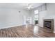 An open-concept living room with a fireplace and wood laminate flooring at 7632 Spruce Run Ct, Las Vegas, NV 89128