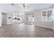 Open living room with kitchen, and double doors to the backyard, featuring neutral tile floors at 7632 Spruce Run Ct, Las Vegas, NV 89128