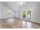 Open floor plan with laminate floors, tall ceilings and french doors leading to outdoor pool at 7632 Spruce Run Ct, Las Vegas, NV 89128