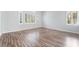 Spacious living area with laminate floors, neutral paint, and an abundance of natural light from large windows at 7632 Spruce Run Ct, Las Vegas, NV 89128