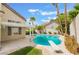 Backyard swimming pool with diving board, surrounded by concrete, grass, and palm trees at 7632 Spruce Run Ct, Las Vegas, NV 89128