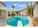 Backyard with swimming pool, diving board, palm trees, and pergola covered patio at 7632 Spruce Run Ct, Las Vegas, NV 89128