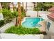 Backyard view of an inviting swimming pool with a spa and mature landscaping at 7632 Spruce Run Ct, Las Vegas, NV 89128