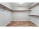 An organized walk-in closet with wood laminate flooring and custom shelving for ample storage at 7632 Spruce Run Ct, Las Vegas, NV 89128