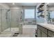 Bathroom featuring a shower over bath with white granite walls at 7821 Mazarine St, North Las Vegas, NV 89084