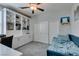 Bright bedroom featuring built-in shelving, sleeper sofa, and carpeted floors at 7821 Mazarine St, North Las Vegas, NV 89084