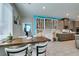 Well-lit dining space with a custom wine rack and easy access to the kitchen at 7821 Mazarine St, North Las Vegas, NV 89084