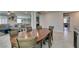 Dining room with hardwood table and chairs, with views into the living room and kitchen at 7821 Mazarine St, North Las Vegas, NV 89084
