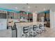 Open kitchen with ample cabinet space, wine rack and large central island with seating at 7821 Mazarine St, North Las Vegas, NV 89084