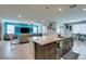 Bright kitchen area with island and ample seating overlooking living room at 7821 Mazarine St, North Las Vegas, NV 89084