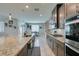 Open kitchen with stainless appliances, stone countertops and breakfast bar at 7821 Mazarine St, North Las Vegas, NV 89084