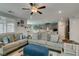 Open-concept living room featuring tile floors, comfortable seating, and views into the adjacent kitchen and dining areas at 7821 Mazarine St, North Las Vegas, NV 89084