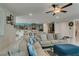 Open living room with tile floors, ceiling fan, and plenty of natural light at 7821 Mazarine St, North Las Vegas, NV 89084