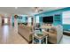 Bright and open living room featuring tile floors, comfortable seating, and modern decor in a stylishly designed space at 7821 Mazarine St, North Las Vegas, NV 89084