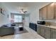 Open-concept living room with kitchen, cozy seating, and ample natural light at 7821 Mazarine St, North Las Vegas, NV 89084