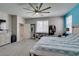 Spacious main bedroom featuring a large ceiling fan, storage shelf, and access to the main bath at 7821 Mazarine St, North Las Vegas, NV 89084